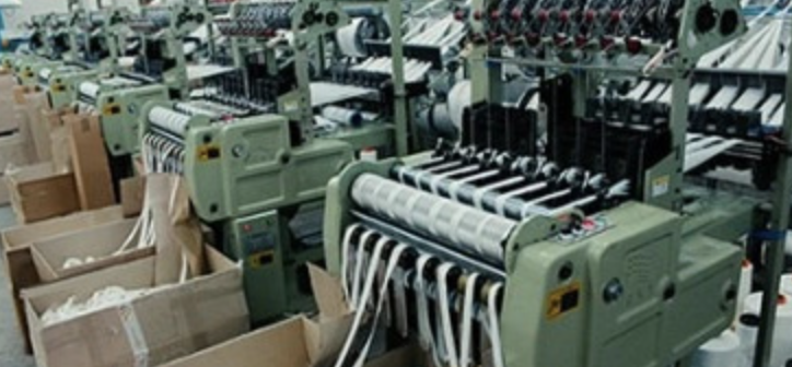 Industrial weaving machines producing custom lanyard webbing at our factory