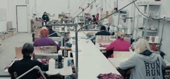 Skilled operators sewing and finishing custom lanyards on the production line